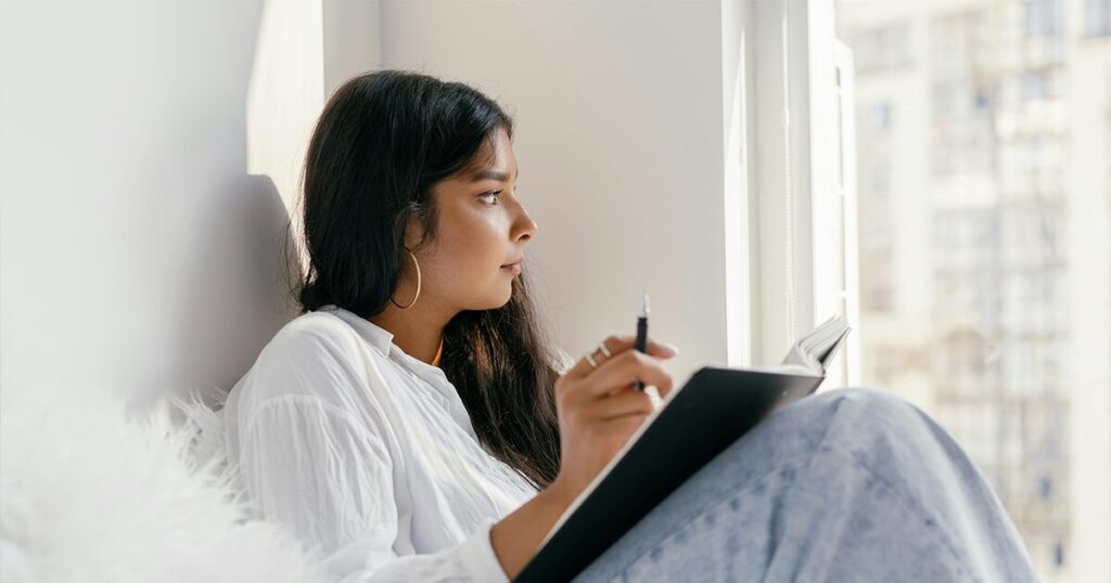 Woman sitting alone looking worried while thinking about her pregnancy options